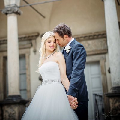 a bride & groom snuggle up at Prague Castle