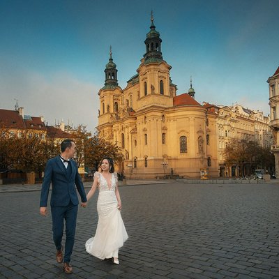 Elegant bride & groom walking through the Old Town Prague