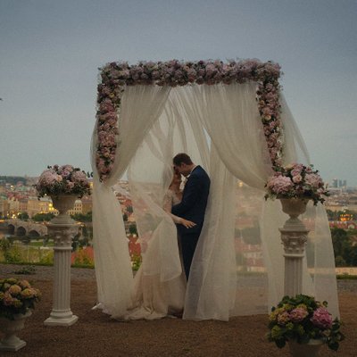 Wedding day kiss at dusk overlooking Prague
