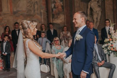 Holding his brides hand during ceremony