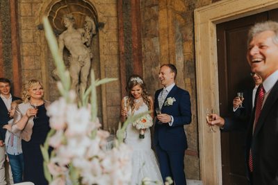 beaming newlyweds during champagne toasts