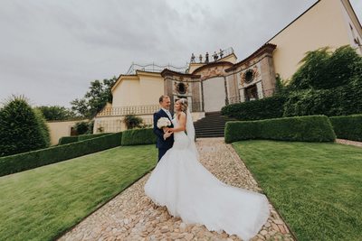 Newlyweds explore the garden as guests watch from above