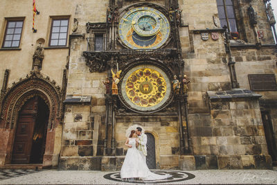 lovers under the Astronomical Clock in the rain Prague