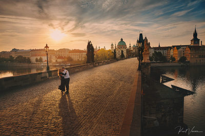 Fine art photo romantic couple embracing Prague sunrise