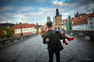 Carrying his fiancee across the Charles Bridge
