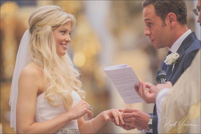 groom placing ring