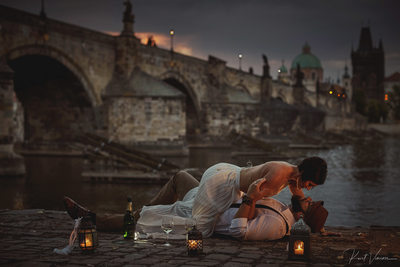 sexy Americans enjoying sunrise with champagne Charles Bridge