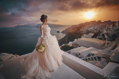 Bride watching the sunset in Santorini  