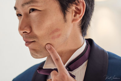 Groom showing off his brides kiss on his cheek