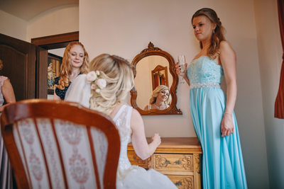 bride checks herself in mirror Castle Hluboka weddings