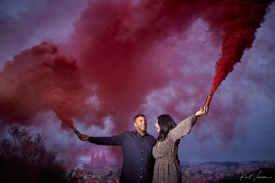 The happily engaged celebrating with flares high above Prague