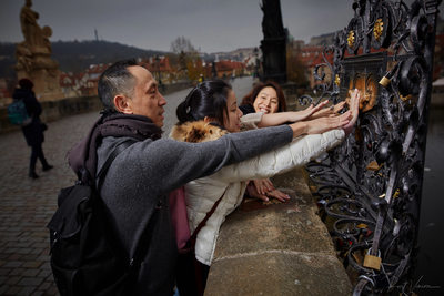 Family making a wish on the Charles Bridge