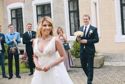 The groom walks up to his bride from behind