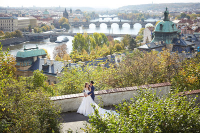 bride & Groom pictured above Prague with Vltava below