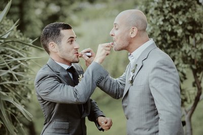 The groom and his mate giving each other lipstick