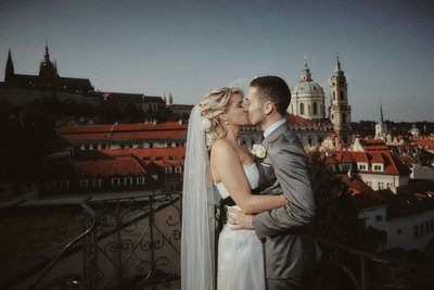 The newlyweds kiss atop the Vrtba Garden in Prague