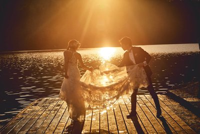 helping brides veil in the Golden Light of Lake Bled