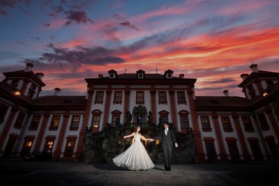 newlyweds enjoying the sunset at the Troja Palace