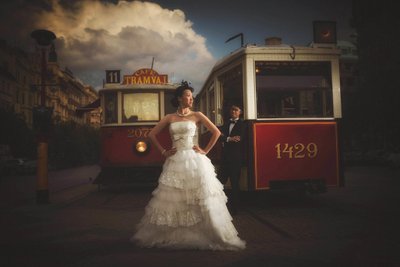 Stylish Newlyweds Posing Near Vintage Trams