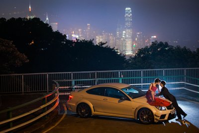 woman in red on Mercedes overlooking Hong Kong