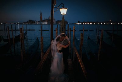 under the gas lamps near the gondolas in Venice