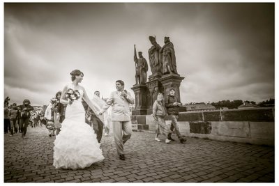 Two Brides Walking Across Charles Bridge