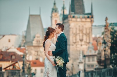 loving embrace atop Charles Bridge