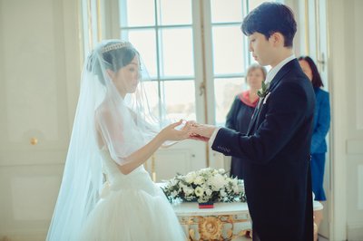 Bride places ring on finger