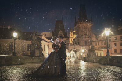 embracing in the rain atop Charles Bridge