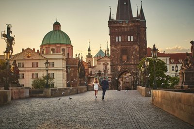 running through pigeons atop Charles Bridge