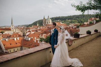 Newlyweds enjoying the scenery high above Prague