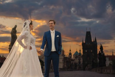 Newlyweds Enjoying the sunrise atop the Charles Bridge