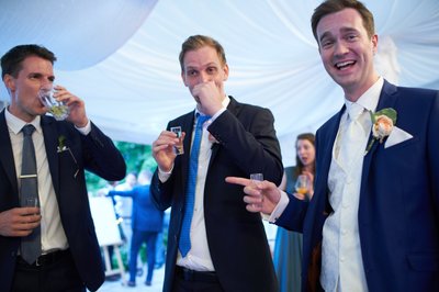 Groom and his best men enjoy a drink at the Villa Richter in Prague