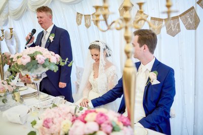 Father speaks as his daughter the bride blushes