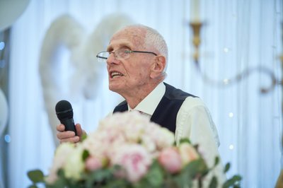 Grandfather toasts newlyweds during Villa Richter celebrations.