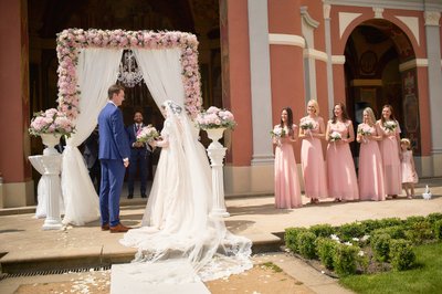 Bridesmaids watch as Bride and Groom exchange vows