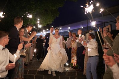 Well-wishers salute the bride & groom with sparklers