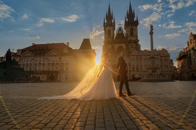 Groom Leading His Bridge Into The Old Town Square At Sunrise