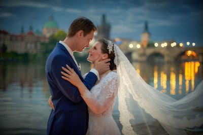 Caressing Bride's Face At Dawn Near Charles Bridge