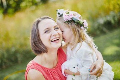 Shy Flower Girl Cuddling Mother