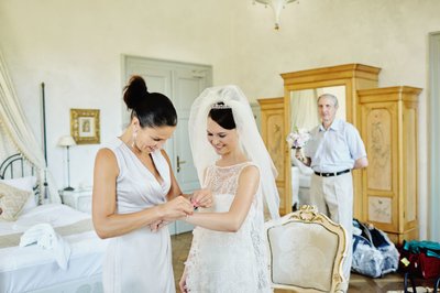 Smiling bride as bracelet is put on