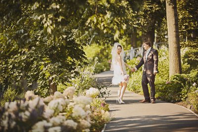 Newlyweds Along Flower-lined path