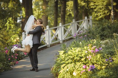 Groom kissing bride amid garden