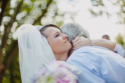 tearful bride embracing father