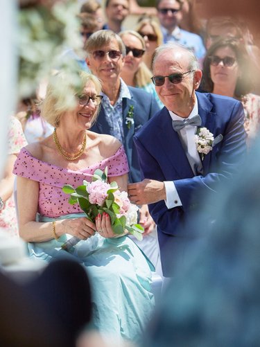 happy parents watching their son marry