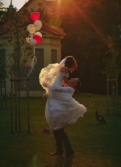 spinning his bride in golden light Prague secret garden