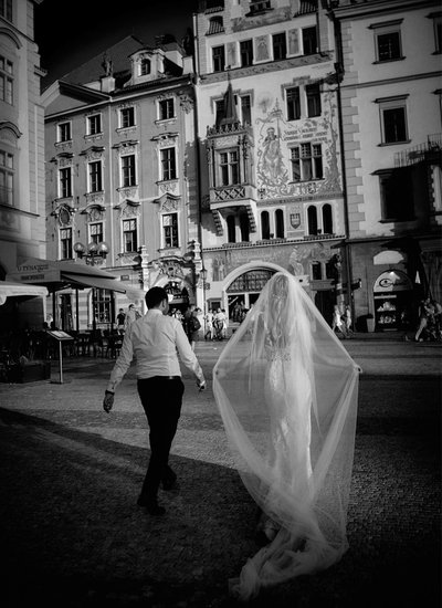 B&W weddings bride walking with groom in the Old Town
