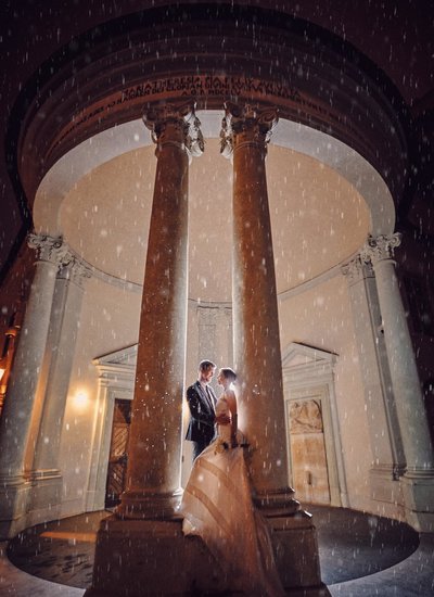 Newlyweds in the rain at Prague Castle at midnight