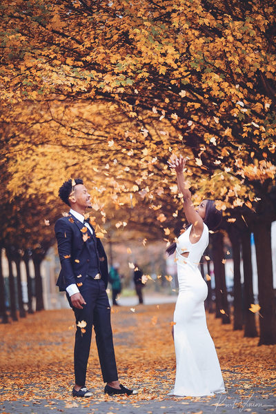 engaged stylish couple with leaves Prague