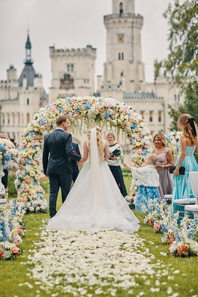 niece extends rose to the bride